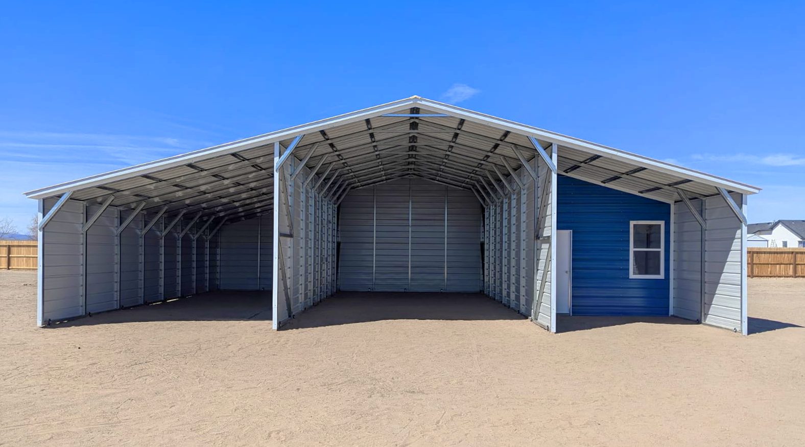 Spacious run-in barn with a blue accent wall and open design, ideal for Arlington Heights IL horse care.