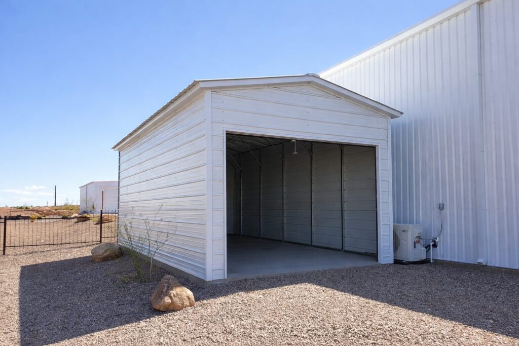 A white mini shed with an open front, showcasing its spacious interior and metal siding.