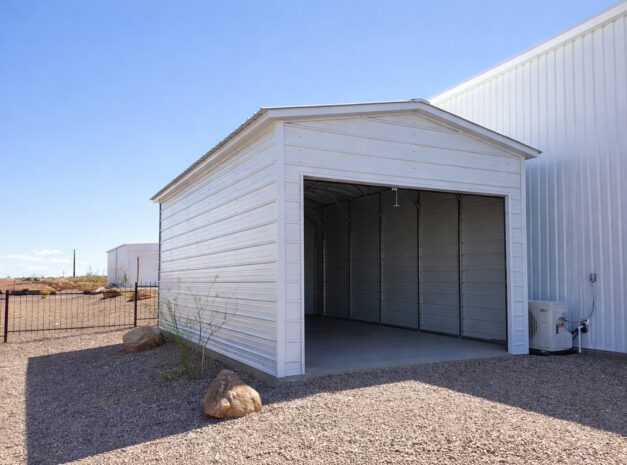 A white mini shed with an open front, showcasing its spacious interior and metal siding.