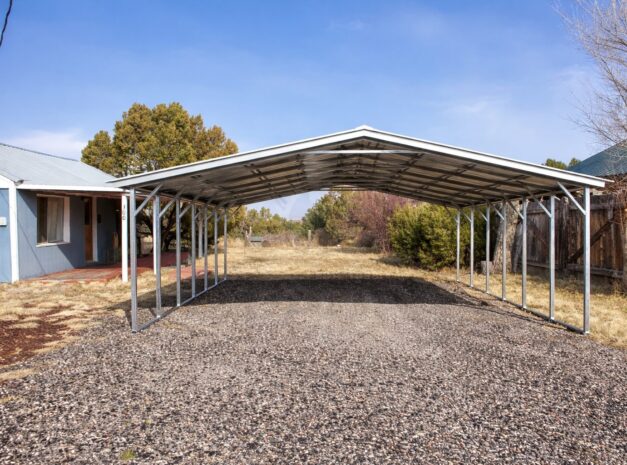 A spacious A-framed carport with a metal roof, set in a grassy area in Ann Arbor, MI.