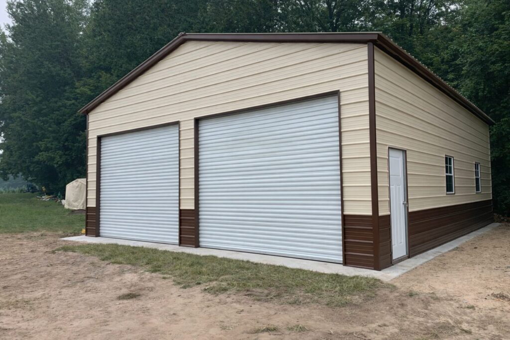 Standard garage building in Atlanta, TX, featuring two large roll-up doors and a beige and brown exterior.