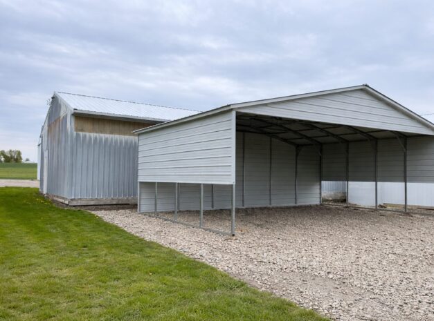 A spacious A-framed carport in Avondale, AZ, featuring a metal structure with a gravel base.