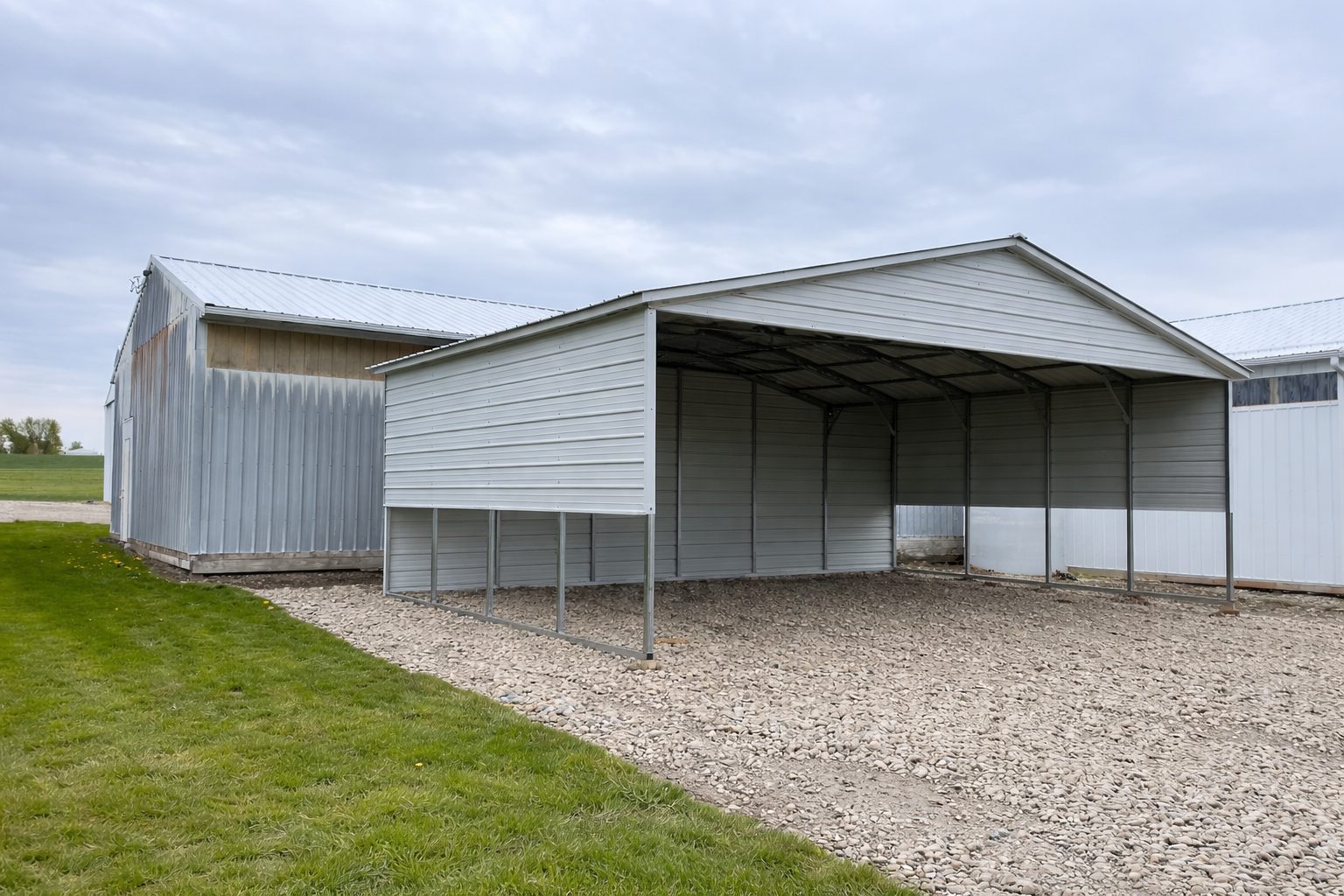 A spacious A-framed carport in Avondale, AZ, featuring a metal structure with a gravel base.