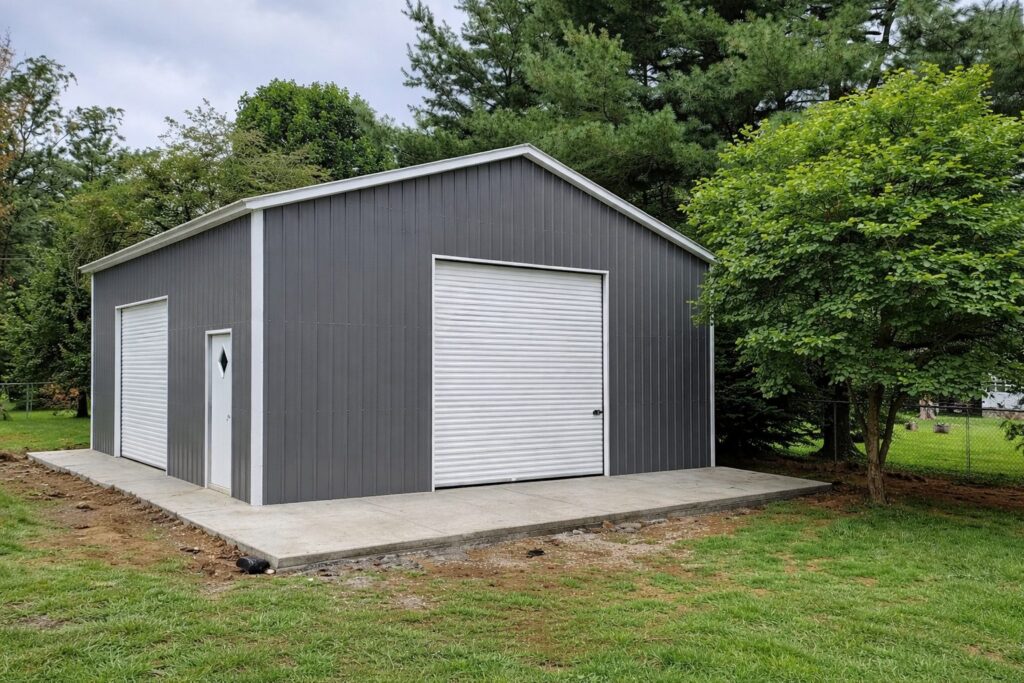 Standard garage in Bad Axe, MI, featuring a gray exterior, large roll-up door, and concrete foundation.