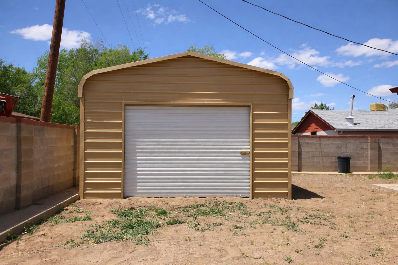 A tan mini shed with a roll-up door, set against a clear blue sky in Beeville, TX.