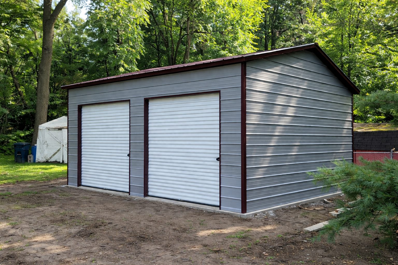 Standard shed in Brownfield, TX, featuring two roll-up doors and a gray exterior surrounded by trees.