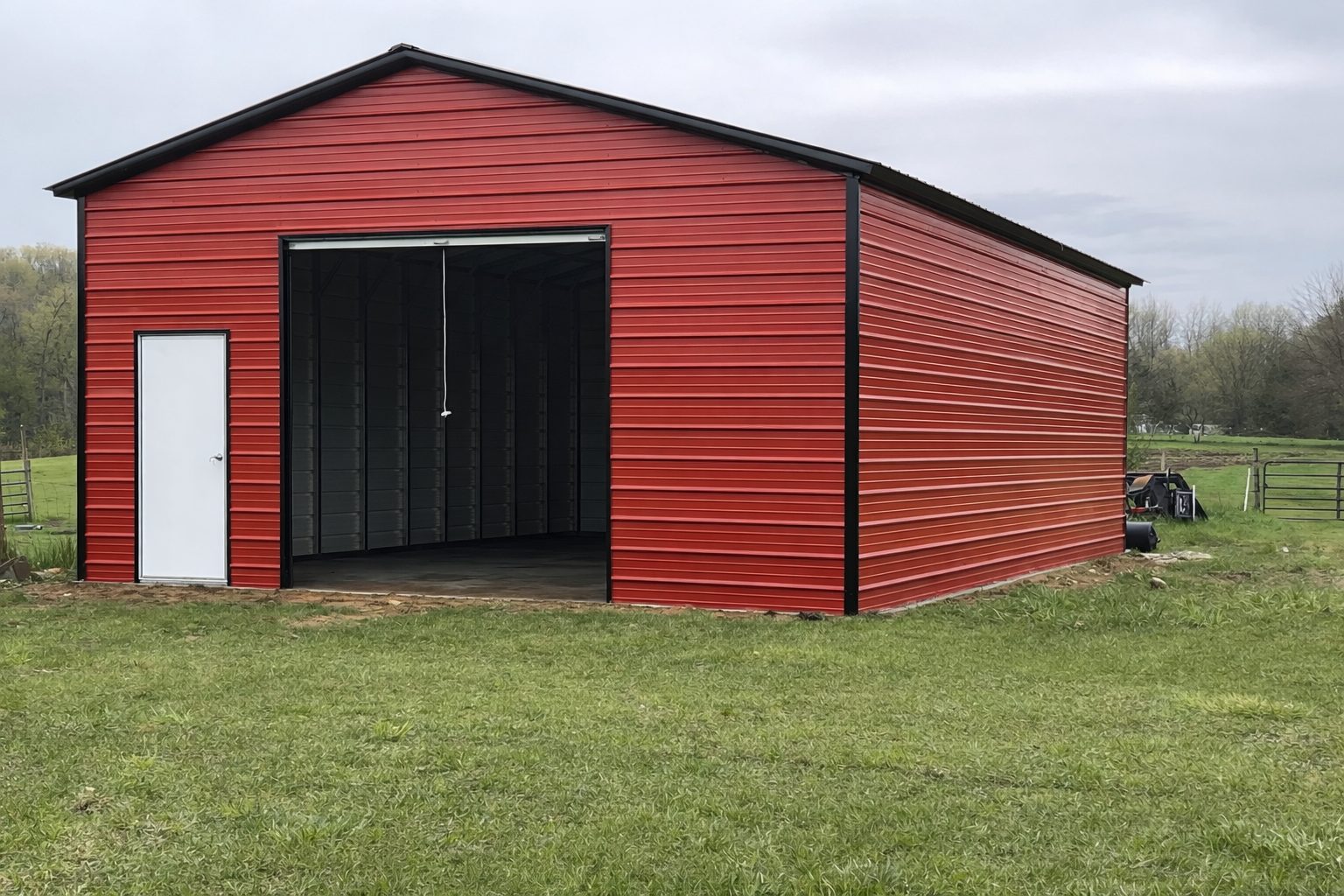 A red standard shed in Brownwood, TX, showcasing a spacious design with a side door and open front.