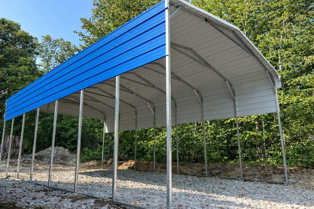 Standard framed carport with a blue roof, set on a gravel base surrounded by trees, ideal for Bullhead City AZ.