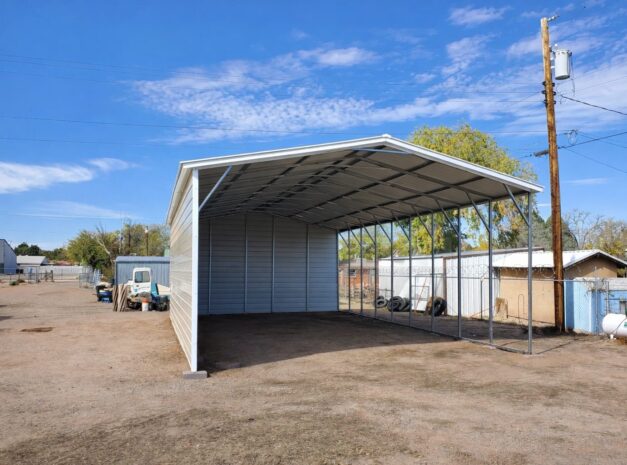 A spacious A-framed carport in Chandler, TX, showcasing a sturdy steel structure with open sides.