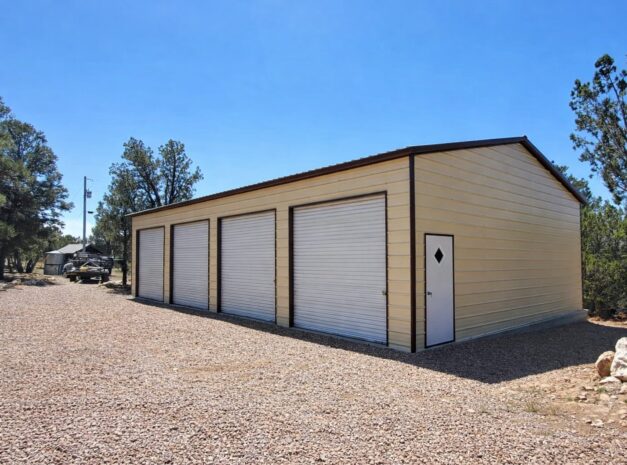Expansive garage with multiple roll-up doors, showcasing a durable steel structure in a natural setting.