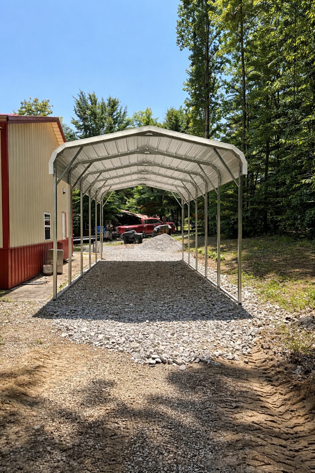Standard carport structure with a gravel driveway, surrounded by trees, showcasing available color options.