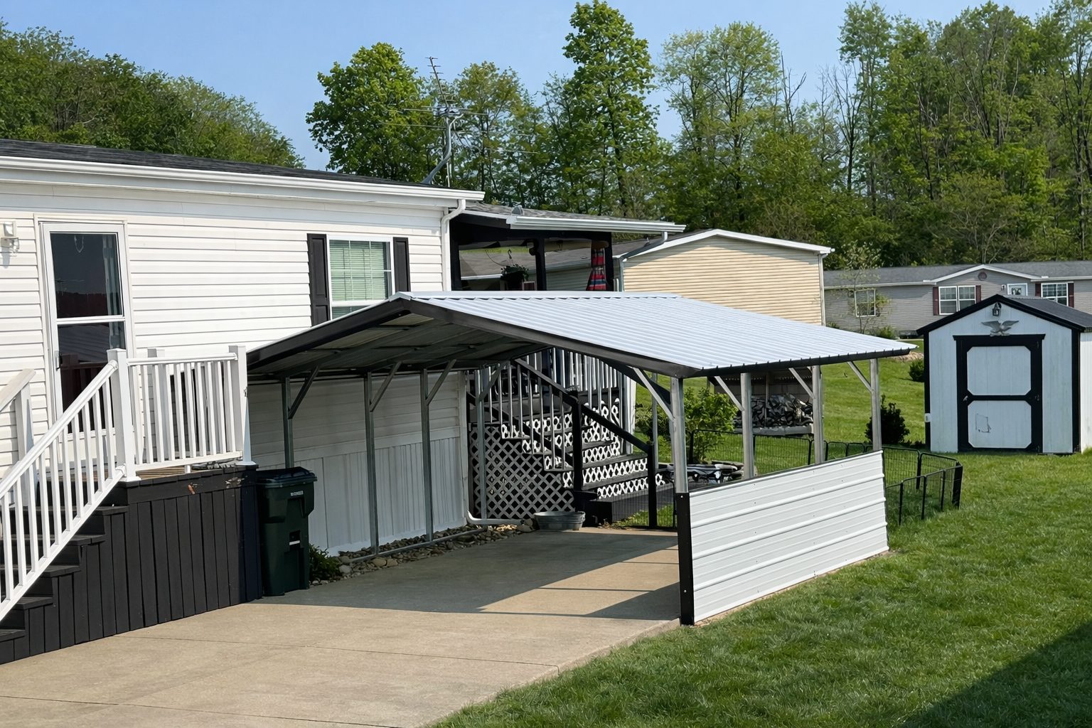 A-frame carport in Douglas, AZ, providing shelter for vehicles next to a home and yard.