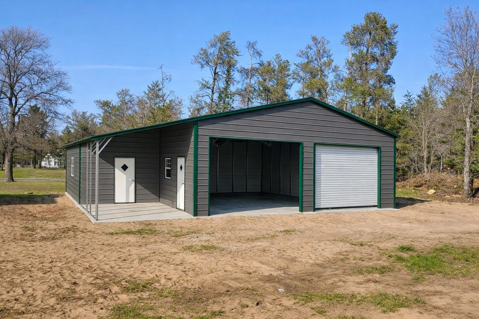 Custom garage in Duluth MN featuring a gray exterior, green trim, and a large roll-up door.
