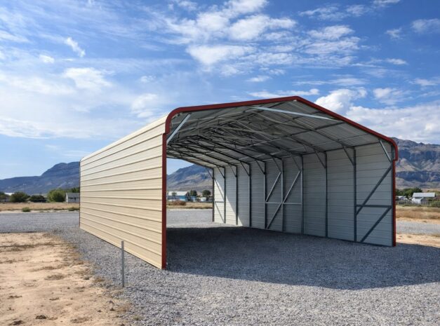 A spacious standard carport with a metal frame and a red roof, set against a clear blue sky in Eau Claire, WI.