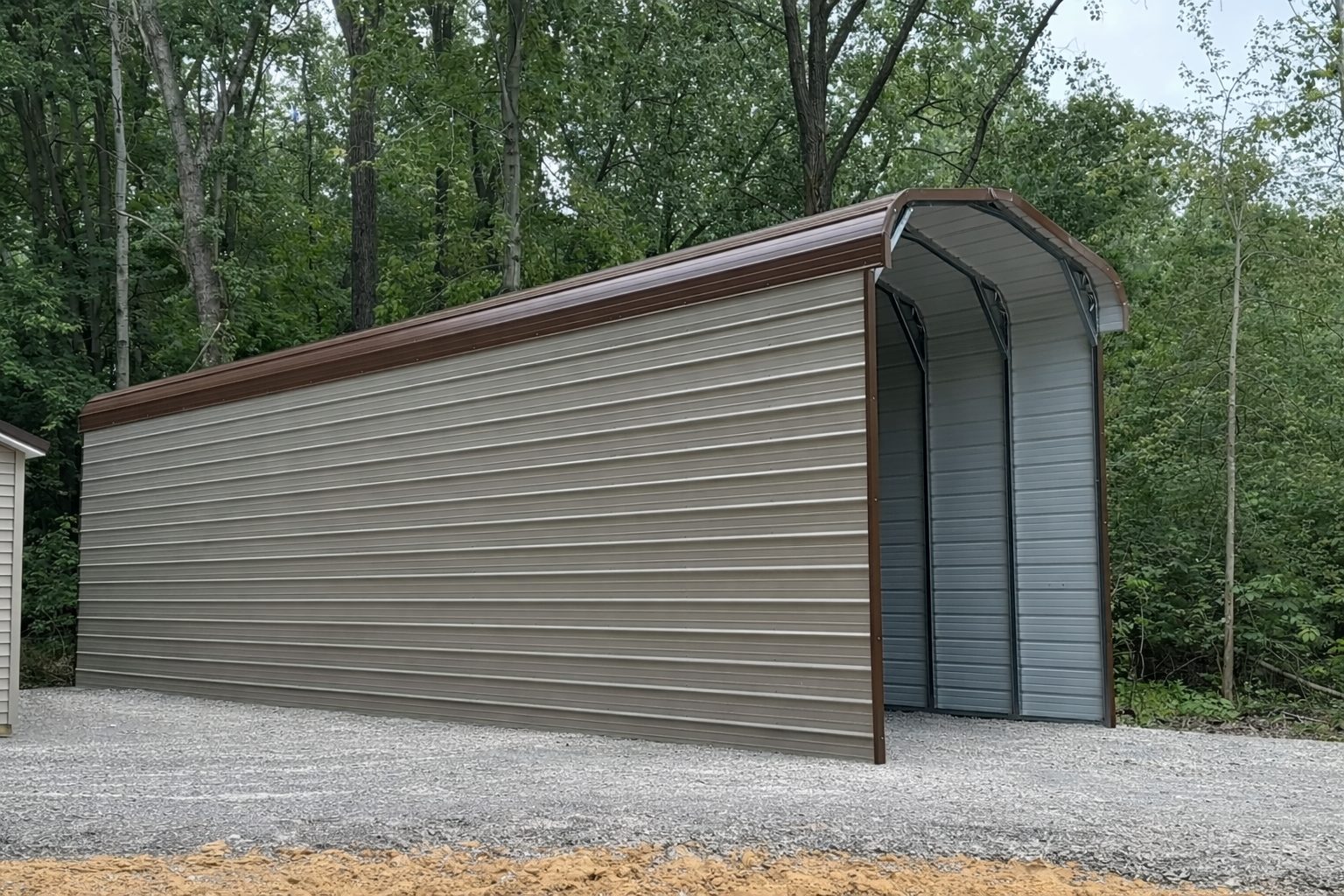Standard framed carport in Flagstaff AZ, showcasing a spacious design with a brown and gray color scheme.