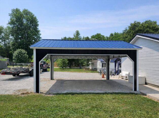 A black and white A-framed carport with a blue metal roof, set in a grassy area near homes in Flint, MI.