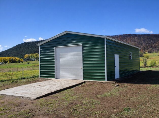 Green standard garage with a large door, set against a scenic landscape in Flint, MI.