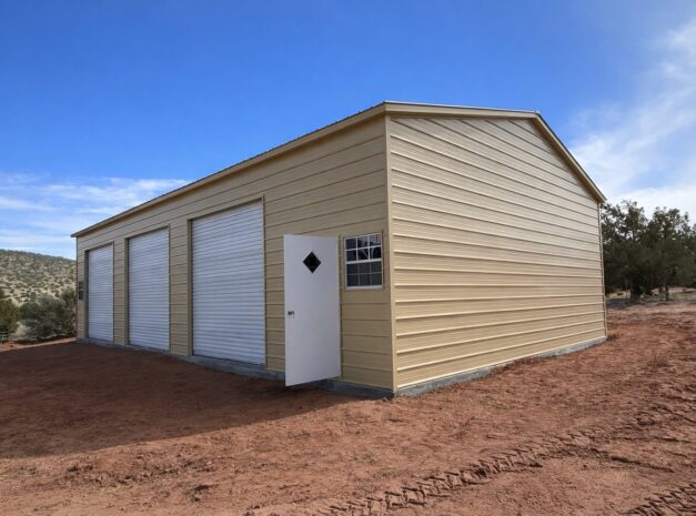 Expansive garage structure with a light-colored exterior and multiple roll-up doors, set in a rural landscape.