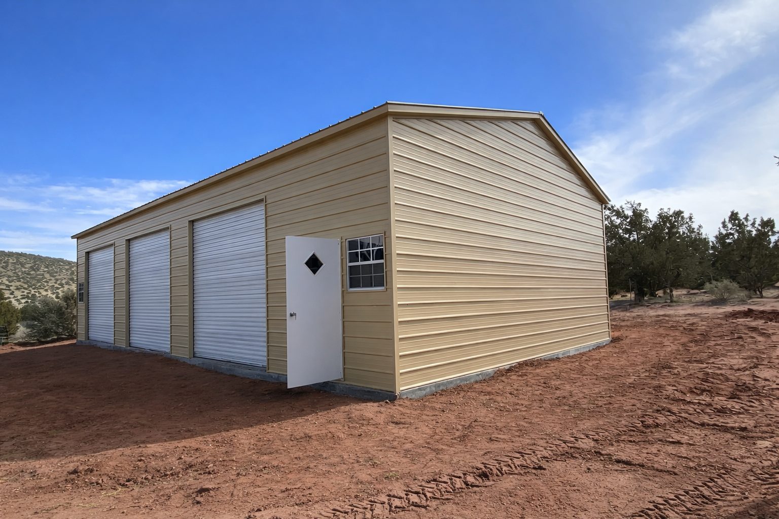 Expansive garage structure with a light-colored exterior and multiple roll-up doors, set in a rural landscape.