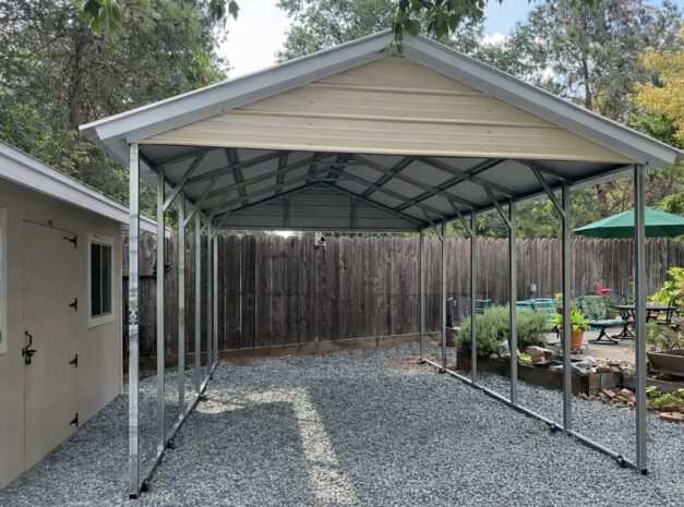A-frame carport with a metal frame and roof, set in a gravel area surrounded by greenery in Grand Prairie, TX.