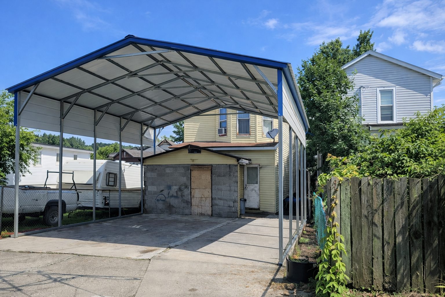 A-frame carport in Hopkinsville KY, showcasing a spacious design with a blue roof and open sides.