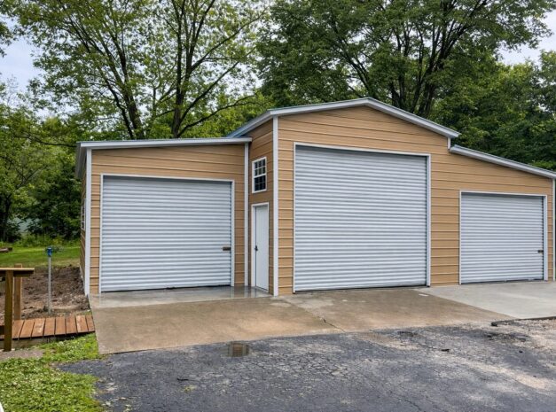 Custom garage in Kansas City with two roll-up doors and a modern design, surrounded by greenery.