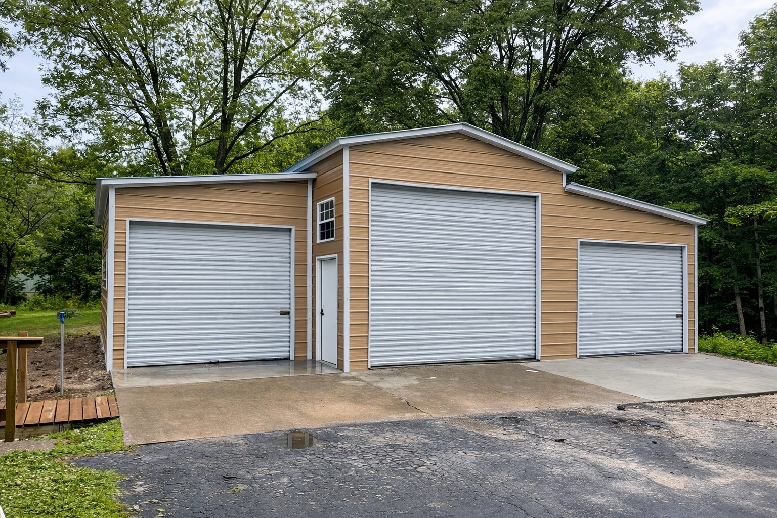 Custom garage in Kansas City with two roll-up doors and a modern design, surrounded by greenery.