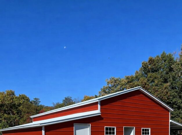 Custom red barn structure with white trim, set against a clear blue sky in Lakewood, OH.