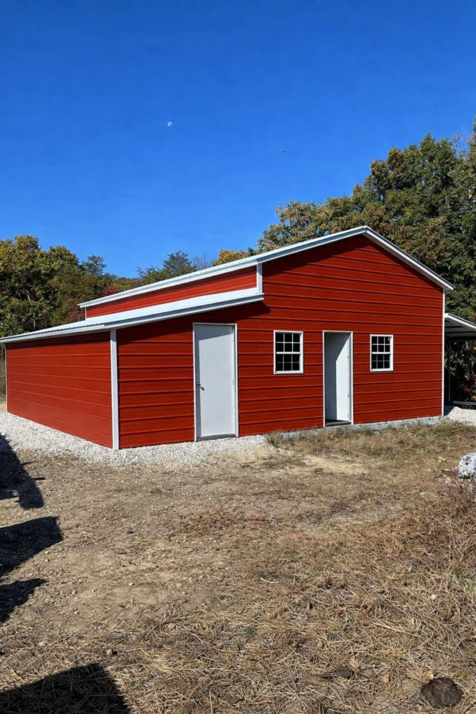 Custom red barn structure with white trim, set against a clear blue sky in Lakewood, OH.