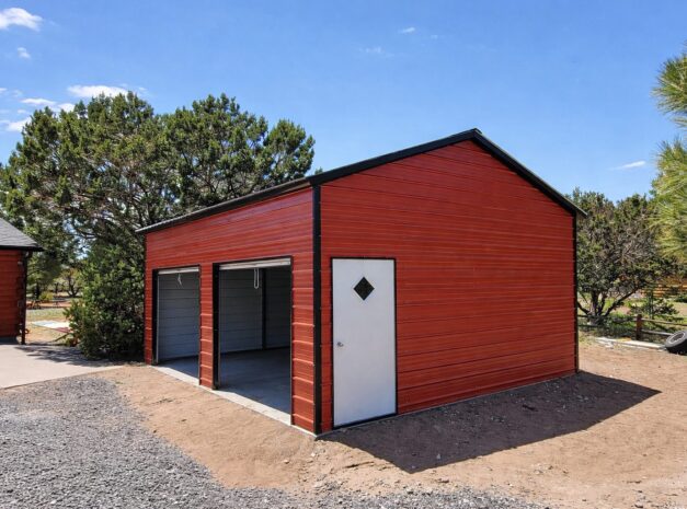 Standard garage in Maryville, MO, featuring a red exterior and two garage doors, surrounded by landscaping.