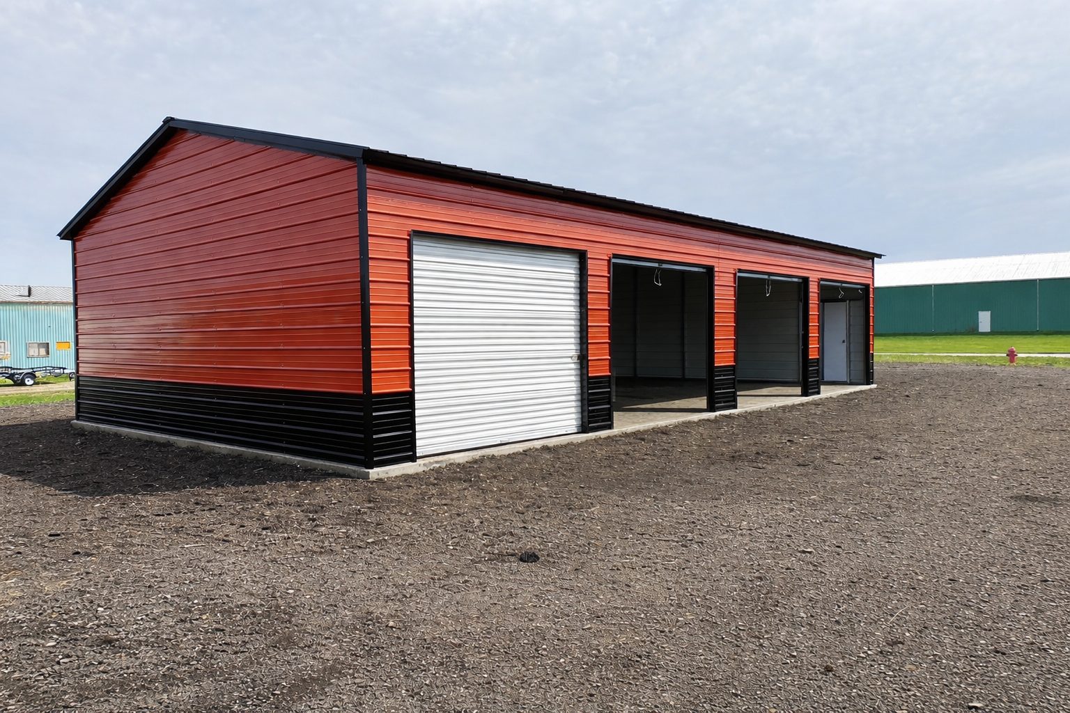 Expansive garage in Mason City, IA, featuring a vibrant red and black exterior with multiple storage bays.