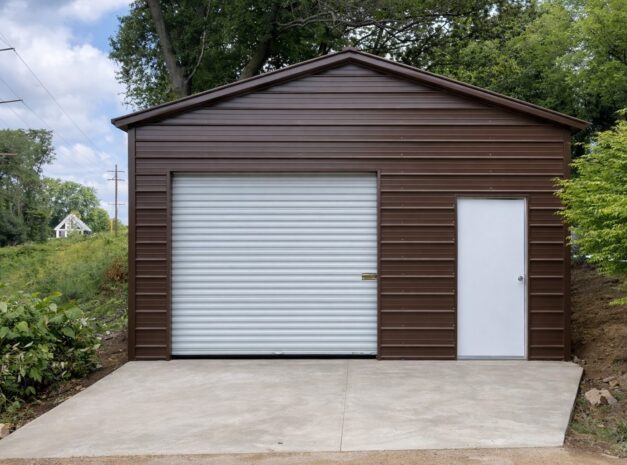 Standard shed in Mexia, TX, featuring a brown metal exterior, roll-up door, and side entrance.