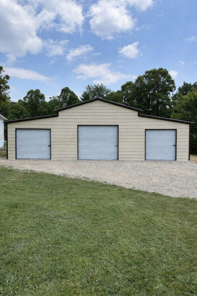 Traditional barn structure in Middletown, OH, featuring three garage doors and a gravel driveway.
