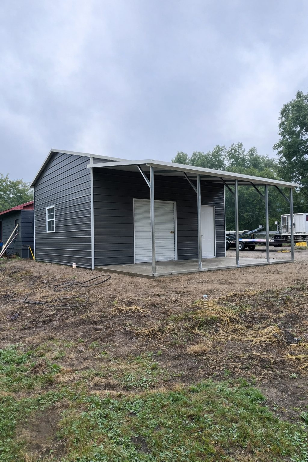 Utility shed in Saginaw TX featuring a modern design with gray siding and double doors.