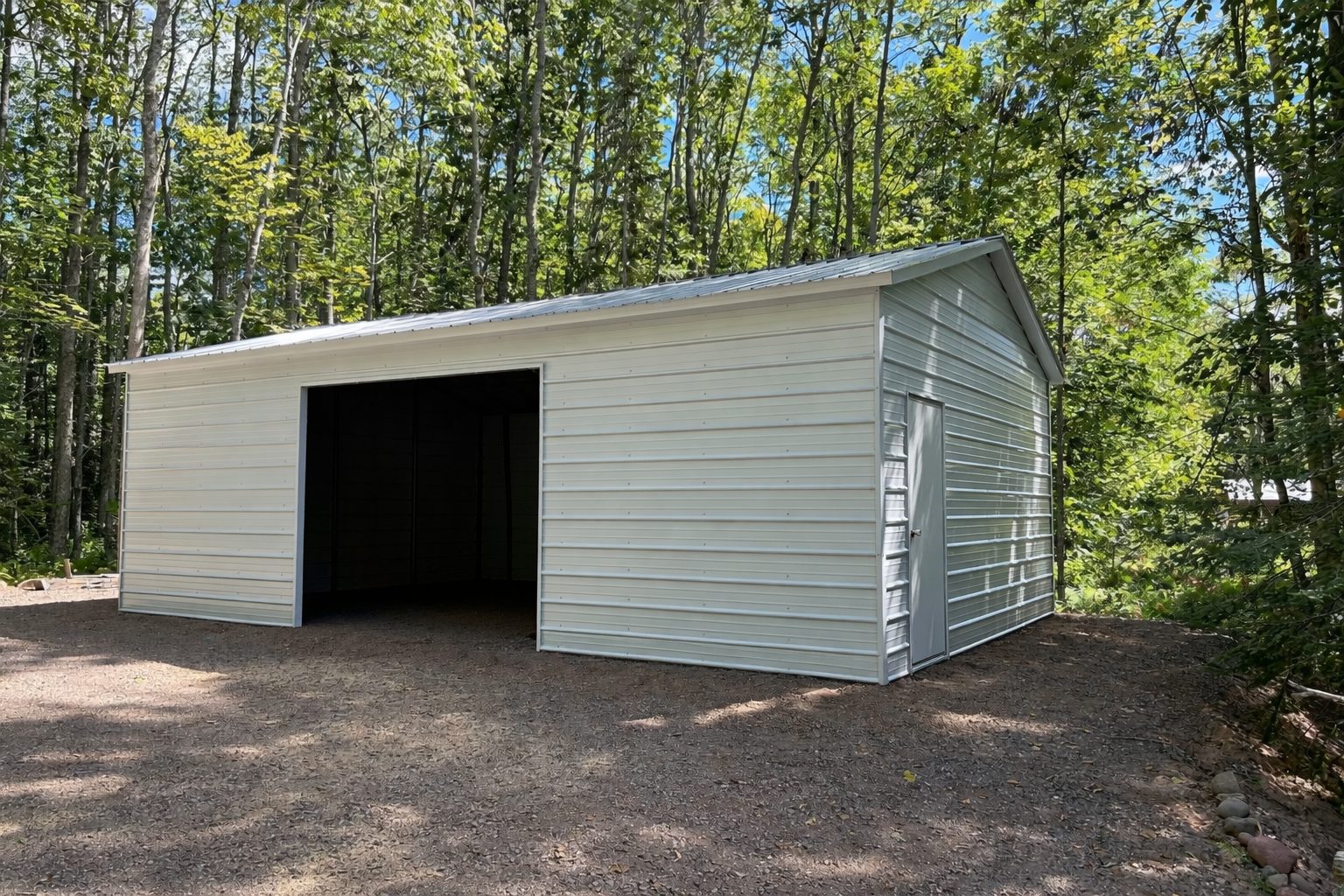 Standard shed in Sanger, TX, featuring a metal exterior and surrounded by trees.