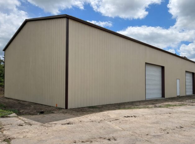 A large beige steel building with roll-up doors, showcasing the Grand Span design in Springtown, TX.