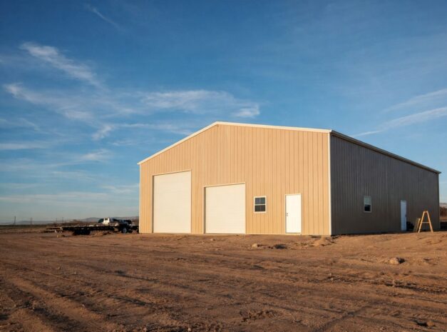 A large steel building in Townsend, WI, showcasing a grand span design with multiple doors and a clear blue sky.