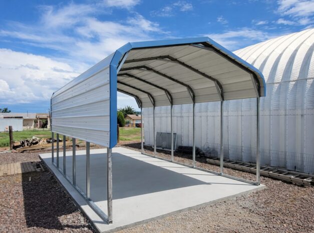 A standard carport structure in Tulsa, featuring a metal frame and a covered roof, set on a concrete base.
