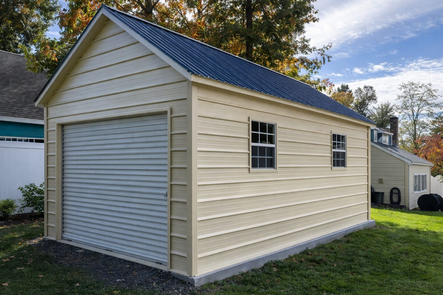 Wilkinson MN mini shed with a light yellow exterior and a blue metal roof, featuring a roll-up garage door.
